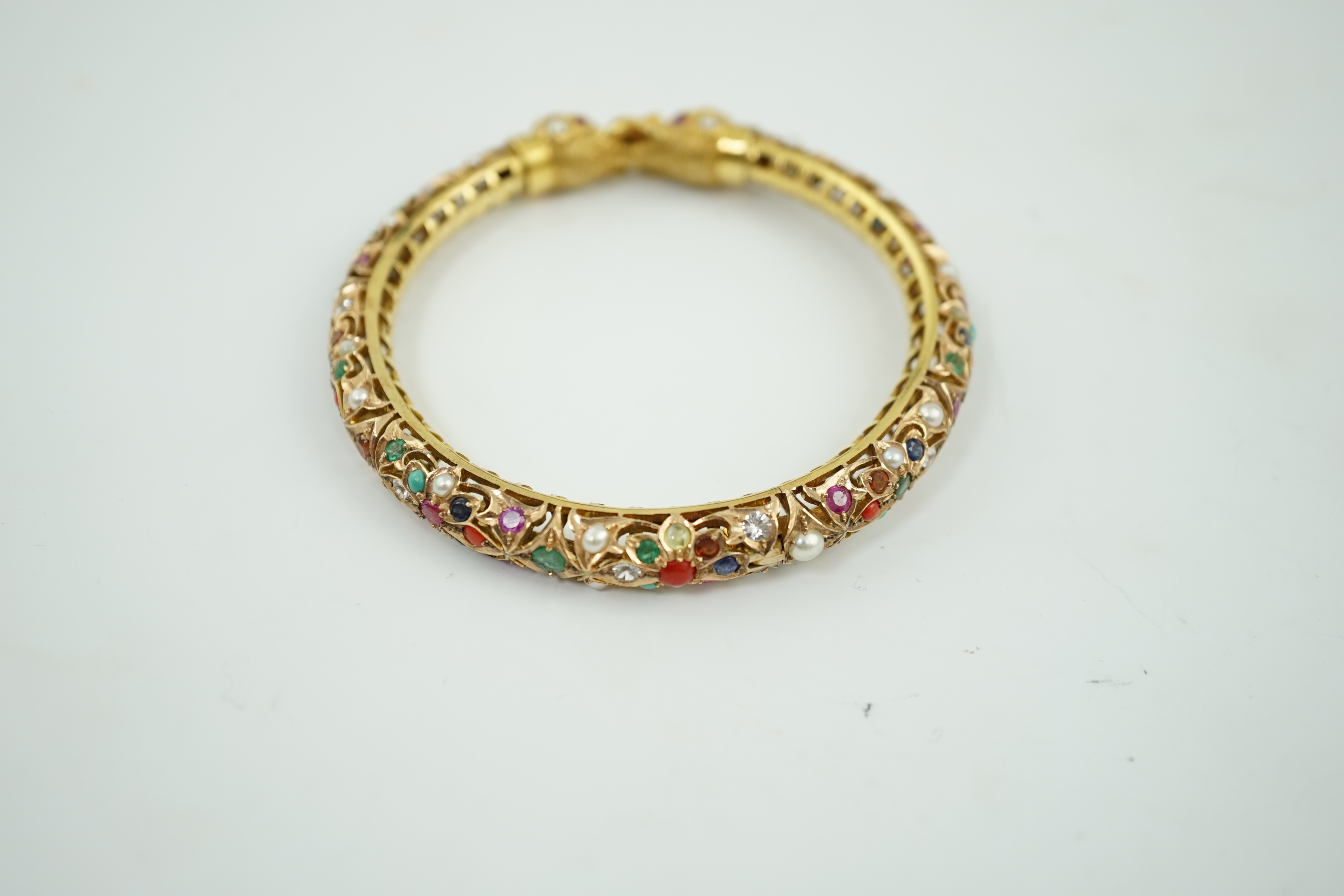 An Indian gold and multi gem set hinged bangle